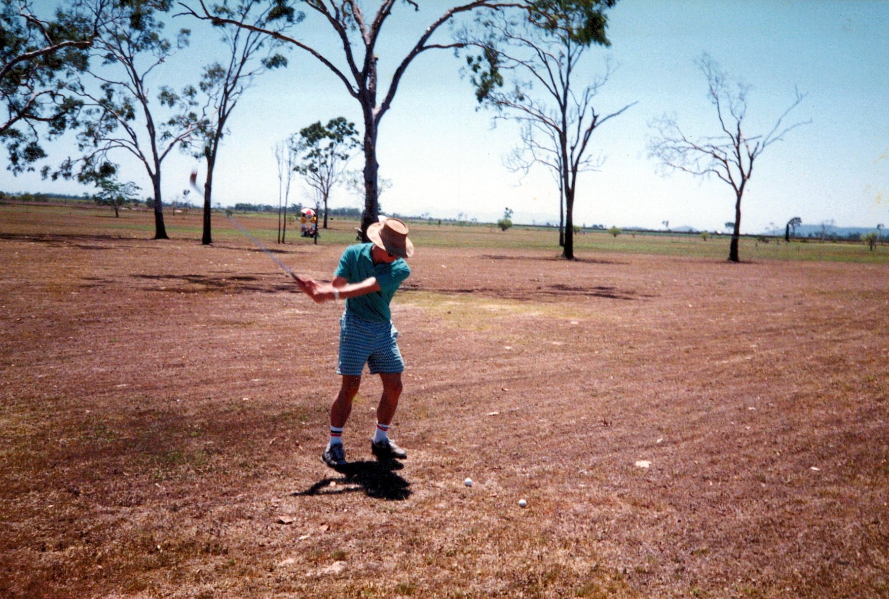 A member tees off on the sun-baked fairways of an earlier era.