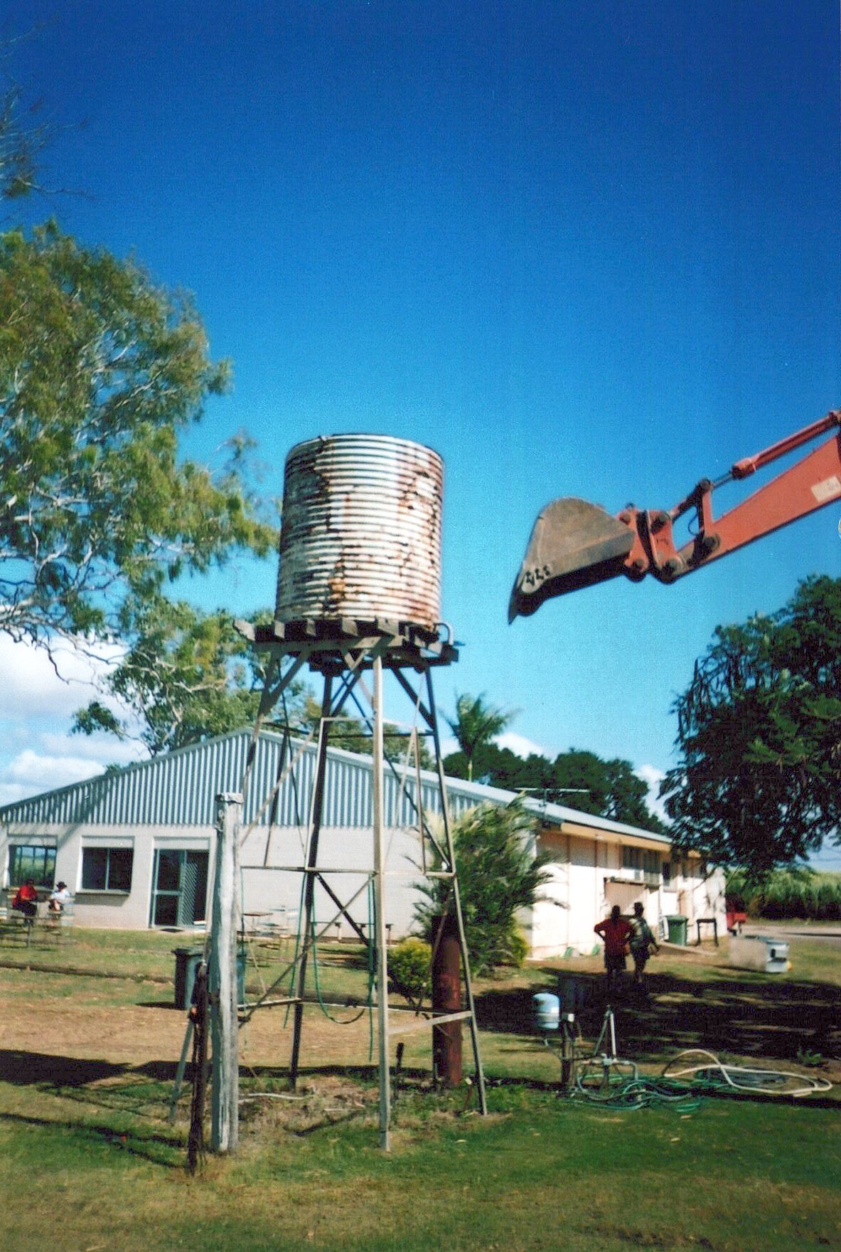 The original elevated water tank is removed beside the clubhouse.