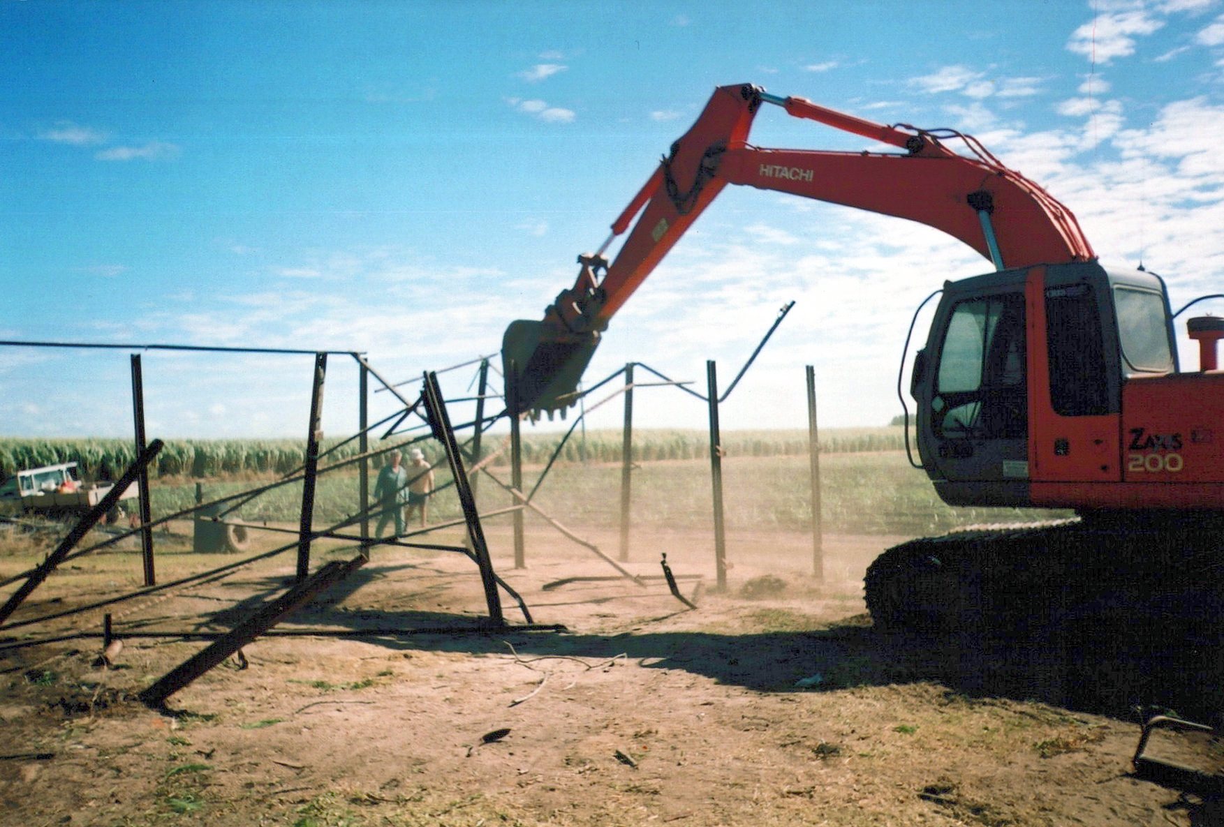 Clearing old boundary fencing beside the cane.